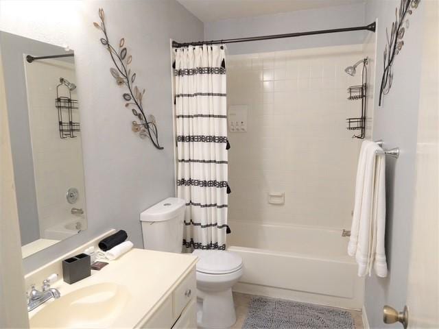 full bathroom featuring shower / bath combo with shower curtain, toilet, and vanity