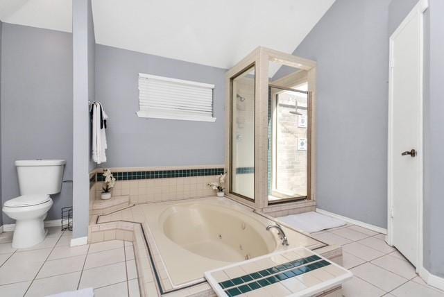 bathroom featuring lofted ceiling, tile patterned floors, toilet, and tiled tub