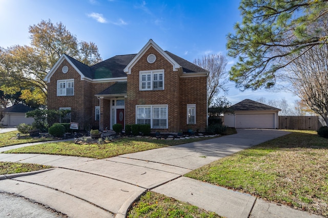 front of property featuring a garage, an outbuilding, and a front yard