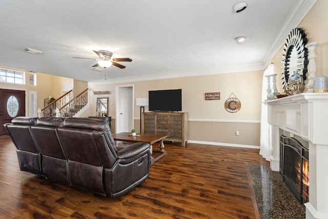 living room with plenty of natural light, dark hardwood / wood-style floors, and crown molding