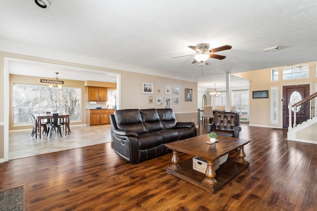 living room featuring a wealth of natural light, crown molding, and hardwood / wood-style flooring