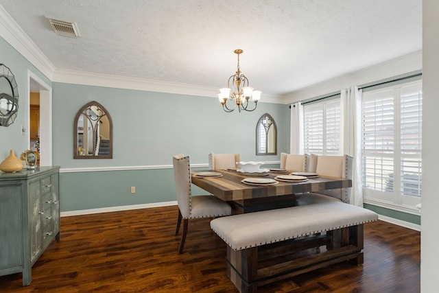 dining area featuring a textured ceiling, dark hardwood / wood-style flooring, and crown molding