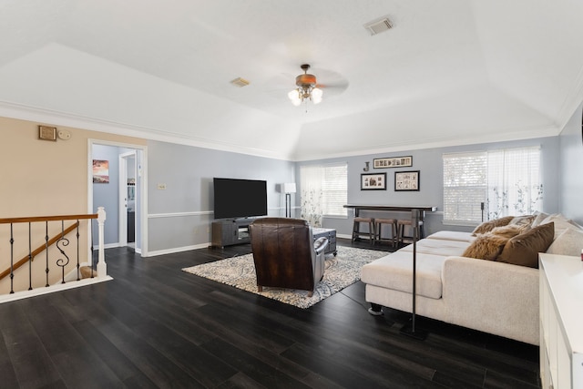 living room featuring ceiling fan, dark hardwood / wood-style flooring, crown molding, and a tray ceiling