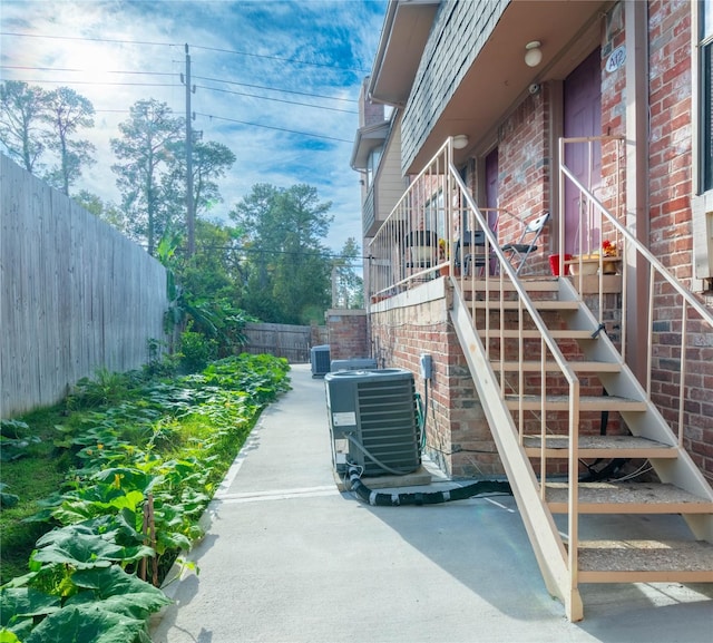 exterior space with cooling unit and a patio