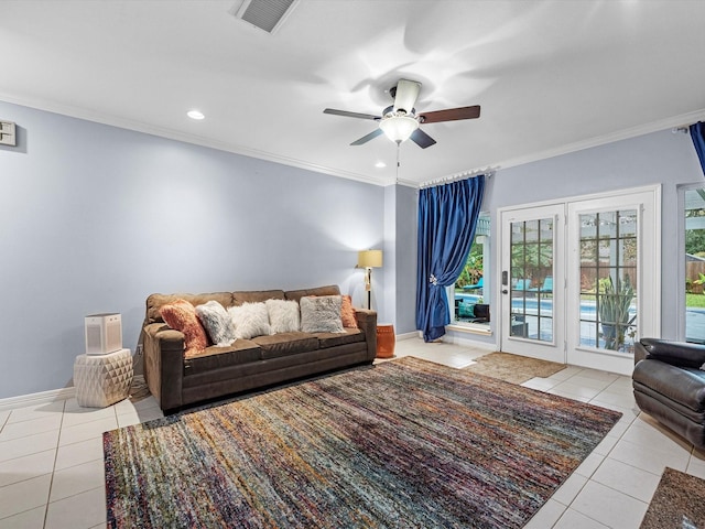 living room with ceiling fan, light tile patterned flooring, and ornamental molding