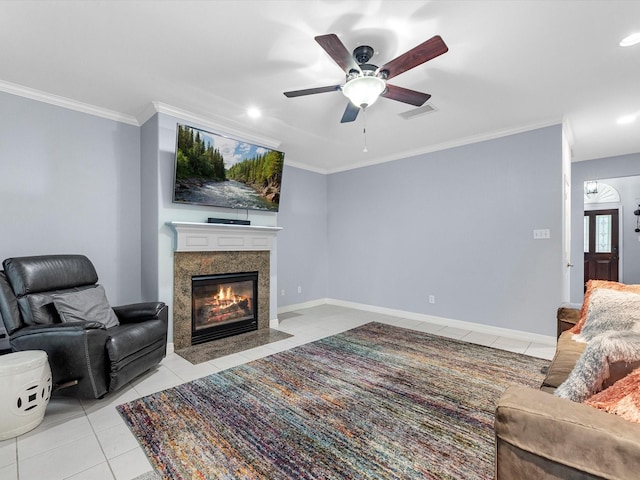 living room with ceiling fan, light tile patterned floors, and ornamental molding