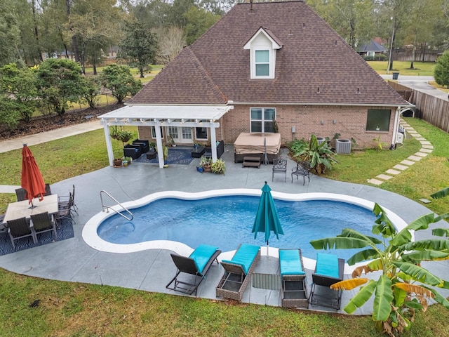 view of pool with a yard, a pergola, cooling unit, and a patio area