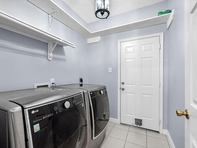 laundry room with light tile patterned flooring and independent washer and dryer