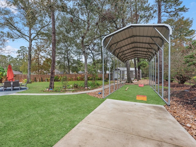 view of property's community with a lawn and a storage shed