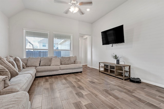 living room featuring lofted ceiling, ceiling fan, and wood-type flooring