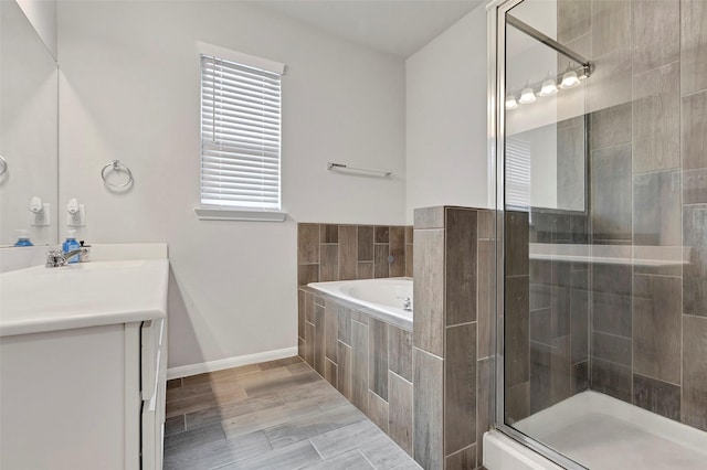 bathroom with separate shower and tub, hardwood / wood-style floors, and vanity