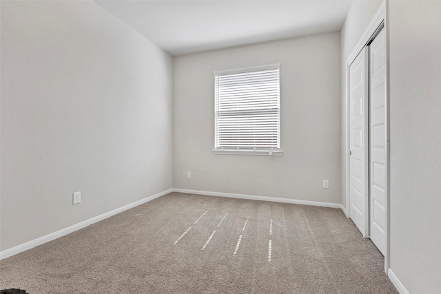 unfurnished bedroom featuring carpet and a closet