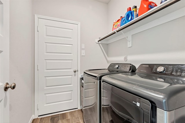 laundry area with washer and dryer and dark hardwood / wood-style flooring