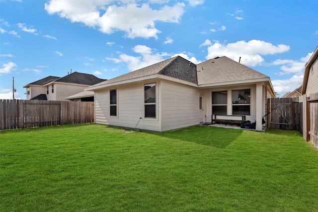 rear view of house with a yard