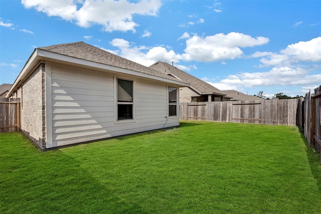 rear view of property featuring a yard