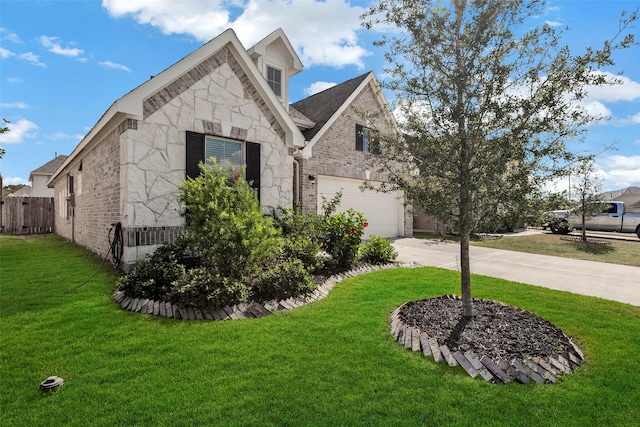 view of front of property with a garage and a front lawn