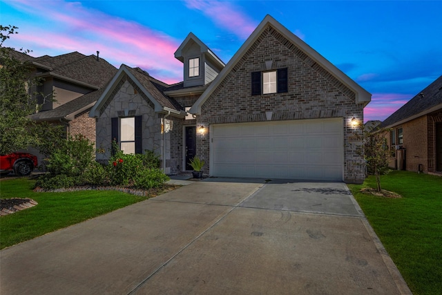 view of front of property featuring a yard and a garage