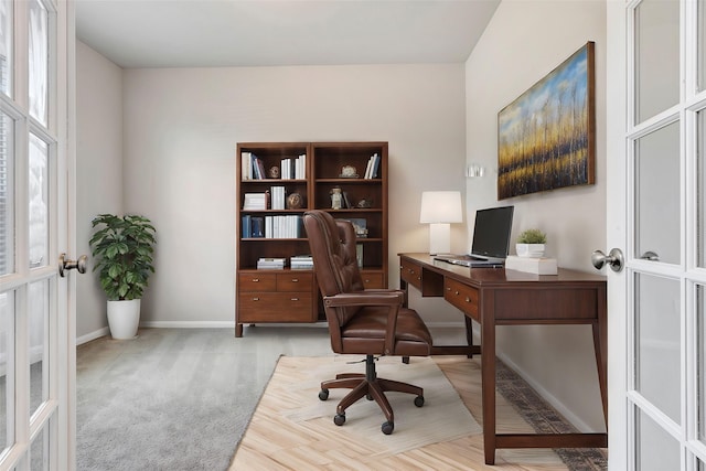 home office featuring french doors and light colored carpet