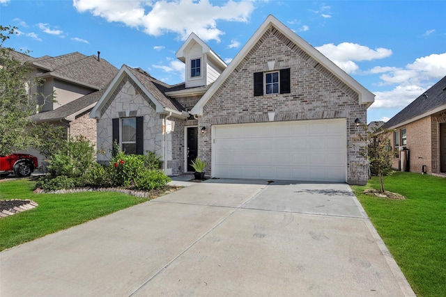 view of front of home with a front yard and a garage