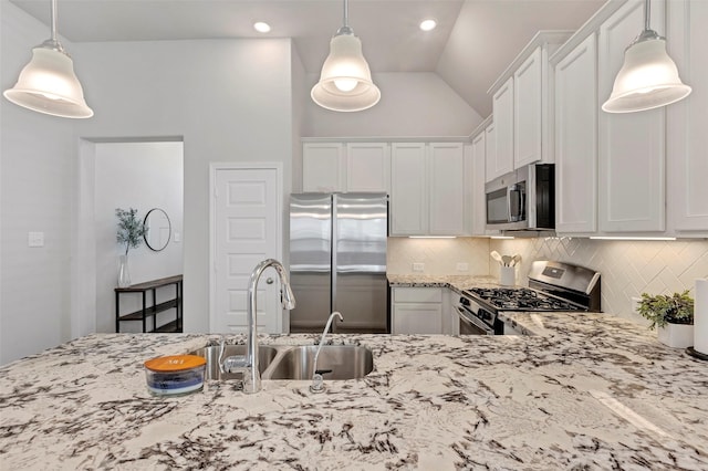 kitchen featuring white cabinets, appliances with stainless steel finishes, hanging light fixtures, and sink