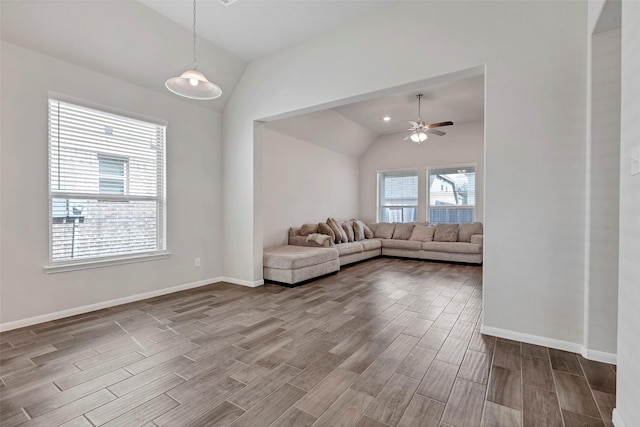 unfurnished living room with hardwood / wood-style flooring, ceiling fan, and lofted ceiling