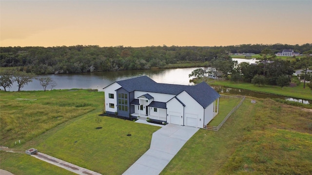 aerial view at dusk with a water view