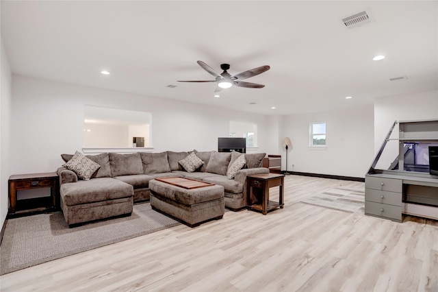 living room with ceiling fan and light wood-type flooring