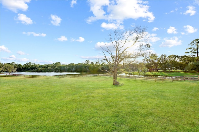 view of yard featuring a rural view and a water view