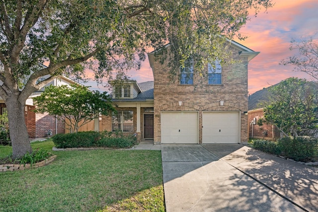 front of property featuring a yard and a garage