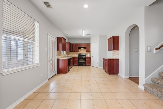 kitchen with black appliances, decorative backsplash, light tile patterned flooring, and sink