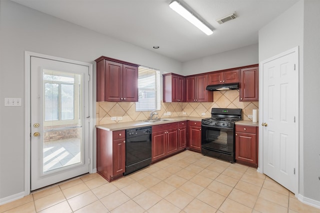 kitchen featuring tasteful backsplash, sink, light tile patterned floors, and black appliances