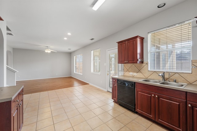 kitchen with ceiling fan, sink, black dishwasher, decorative backsplash, and light tile patterned flooring