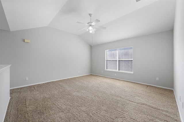 empty room with ceiling fan, carpet, and lofted ceiling