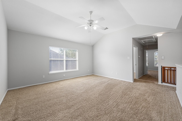 spare room with ceiling fan, carpet, and vaulted ceiling