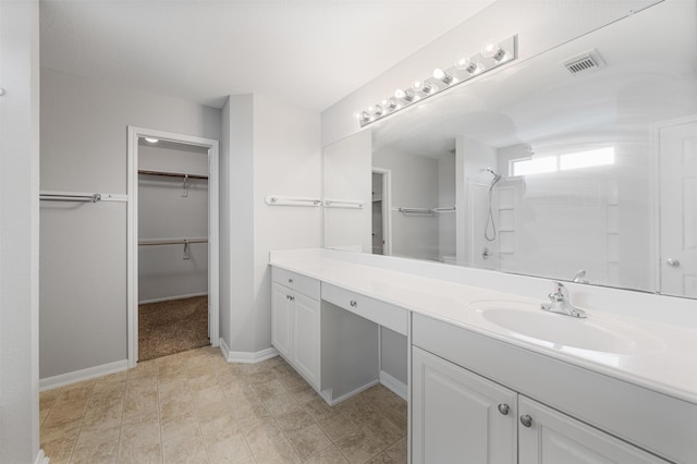 bathroom with a shower and vanity