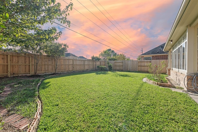 view of yard at dusk