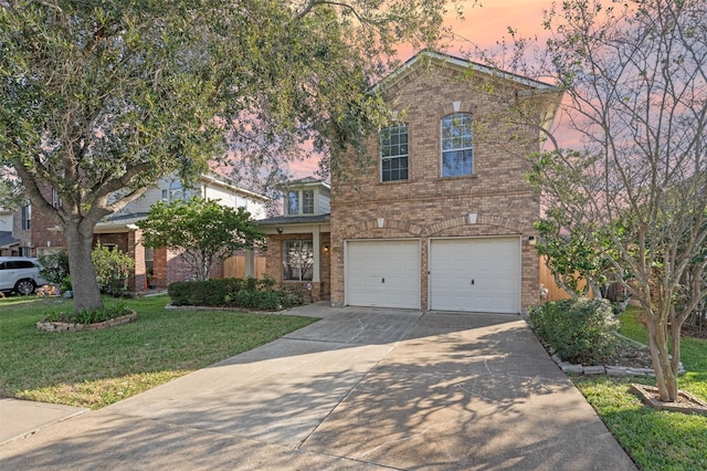 view of front of property with a garage and a yard