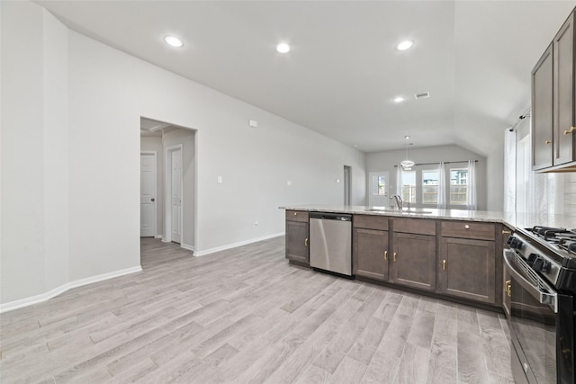 kitchen featuring light stone counters, light hardwood / wood-style flooring, stainless steel appliances, and sink