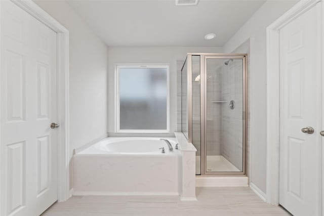 bathroom featuring plus walk in shower