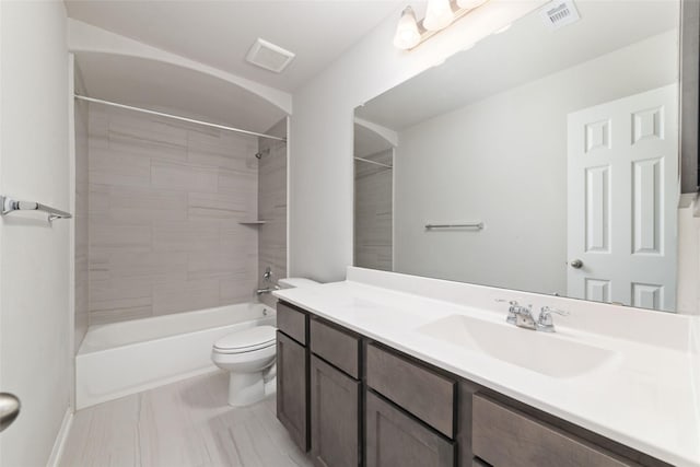 full bathroom featuring vanity, toilet, and tiled shower / bath