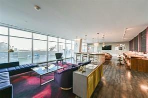 living room with dark wood-type flooring and expansive windows