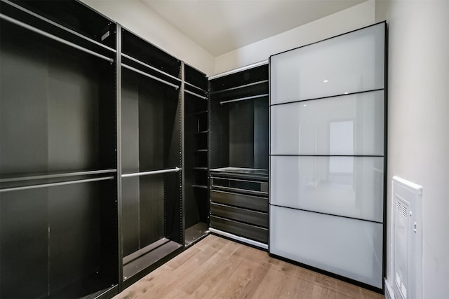 spacious closet featuring light hardwood / wood-style floors