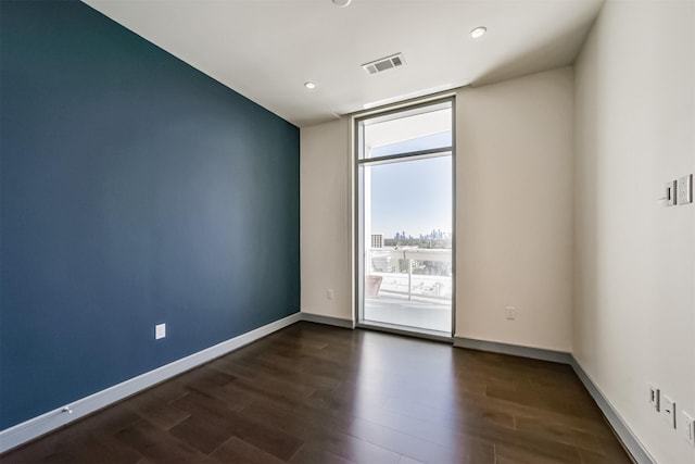 spare room with dark hardwood / wood-style floors