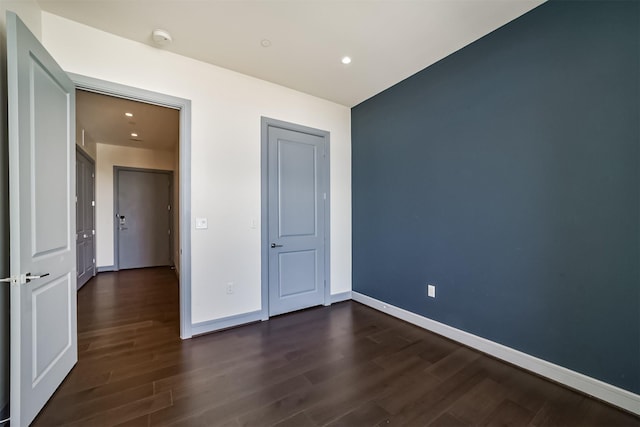 unfurnished bedroom featuring dark hardwood / wood-style flooring