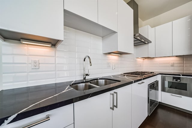 kitchen featuring backsplash, white cabinetry, wall chimney exhaust hood, and sink