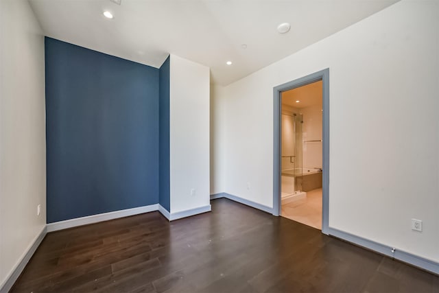 spare room with dark hardwood / wood-style flooring