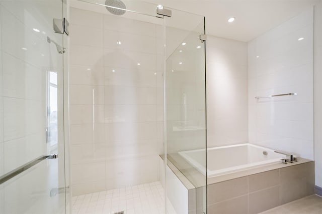 bathroom featuring separate shower and tub