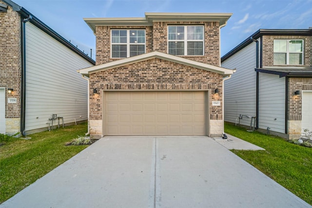 view of property featuring a front yard and a garage