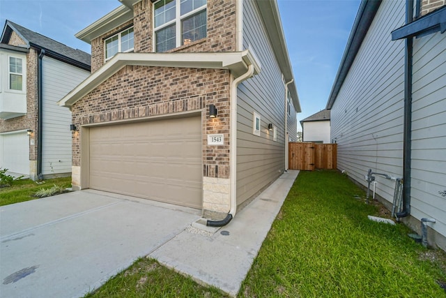 view of side of property with a garage and a yard