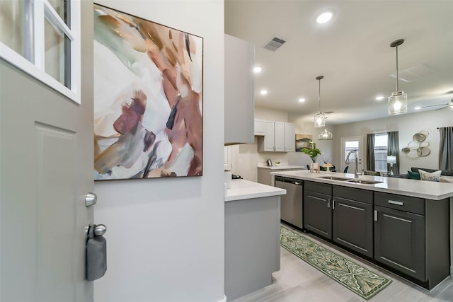 kitchen with gray cabinetry, sink, decorative light fixtures, dishwasher, and a kitchen island